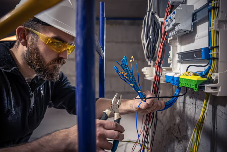 Professional electrician in safety gear showcasing top trade careers in demand for 2025
