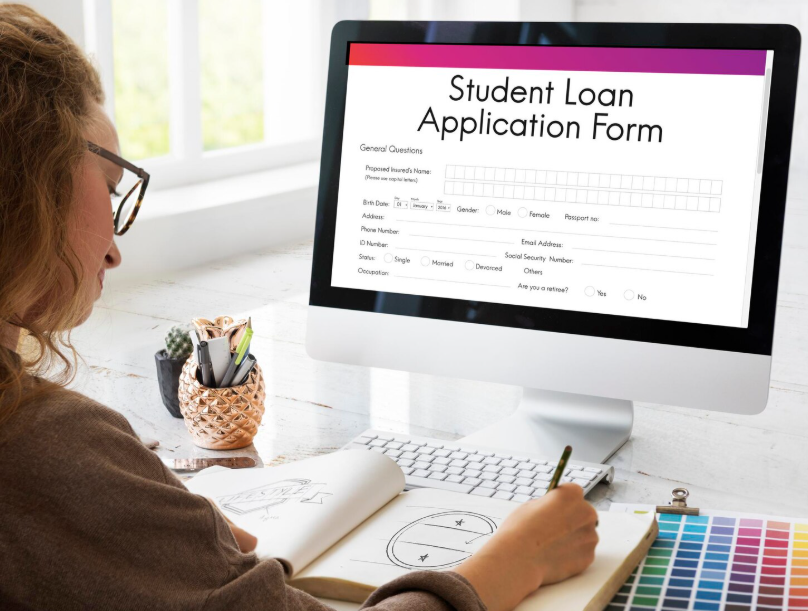 Student filling out a student loan application form on a computer