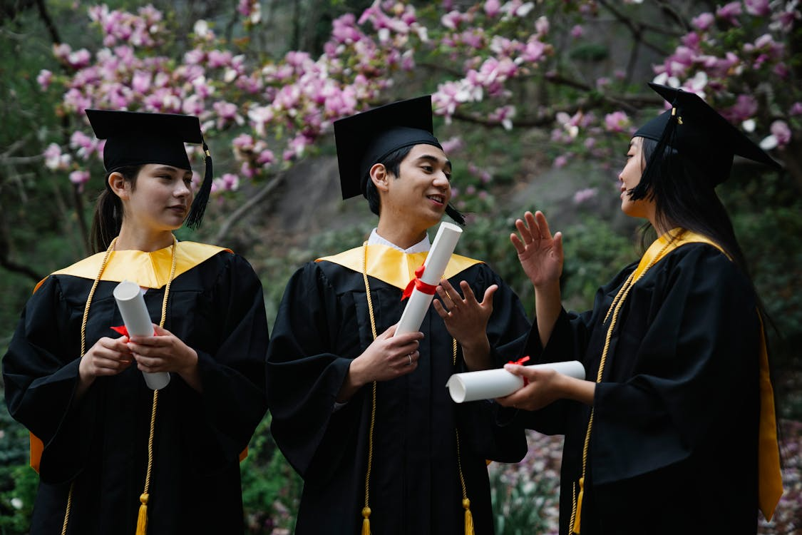 College graduates in caps and gowns celebrating majors that lead to high-paying jobs
