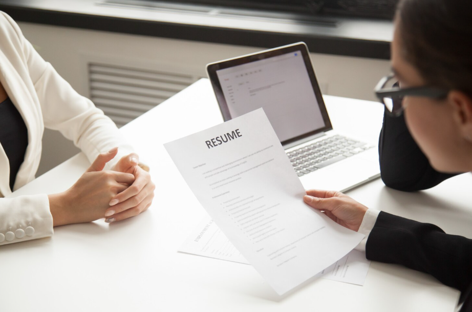 Hiring manager evaluating resume representing skills vs degrees in the job market