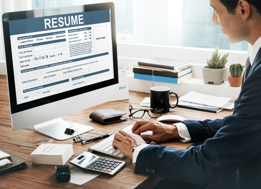 Employer reviewing resume, highlighting the importance of skills vs school background