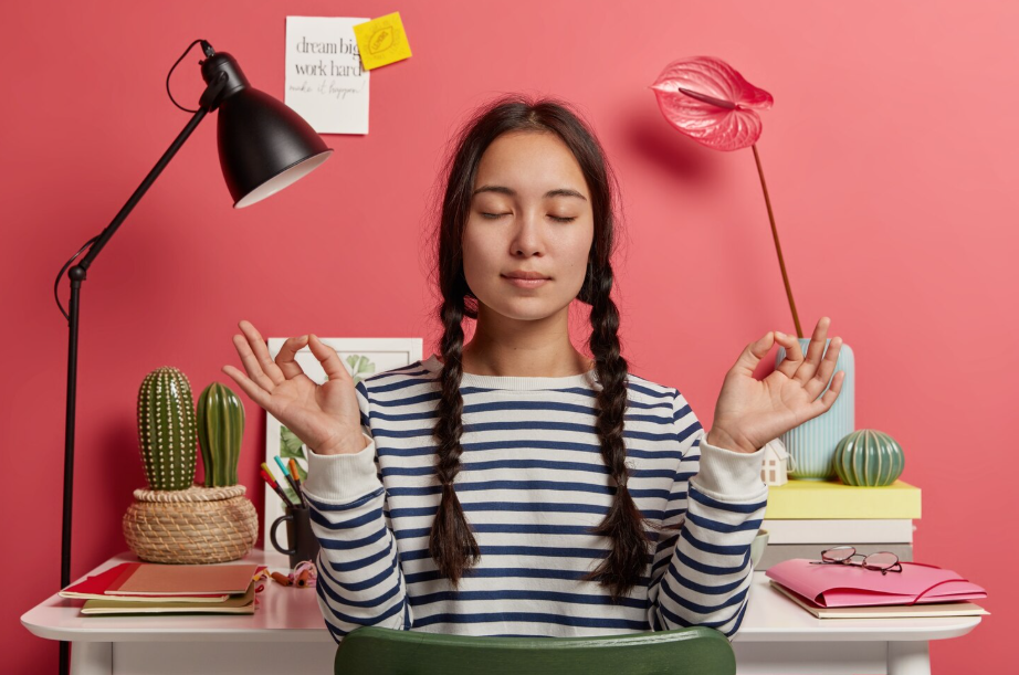 Student practicing mindfulness meditation, highlighting balancing mental health while studying