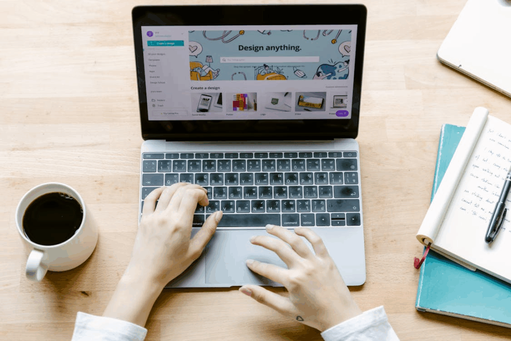 Student working on a laptop designing graphics, representing freelance and creative side hustles