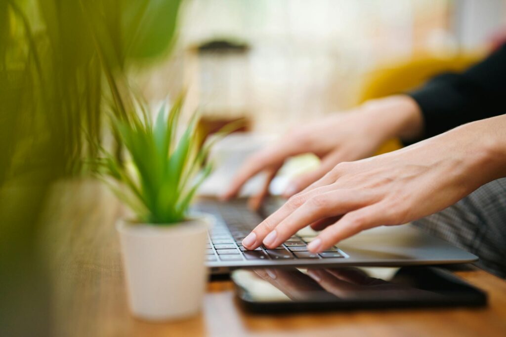 hands typing on laptop
